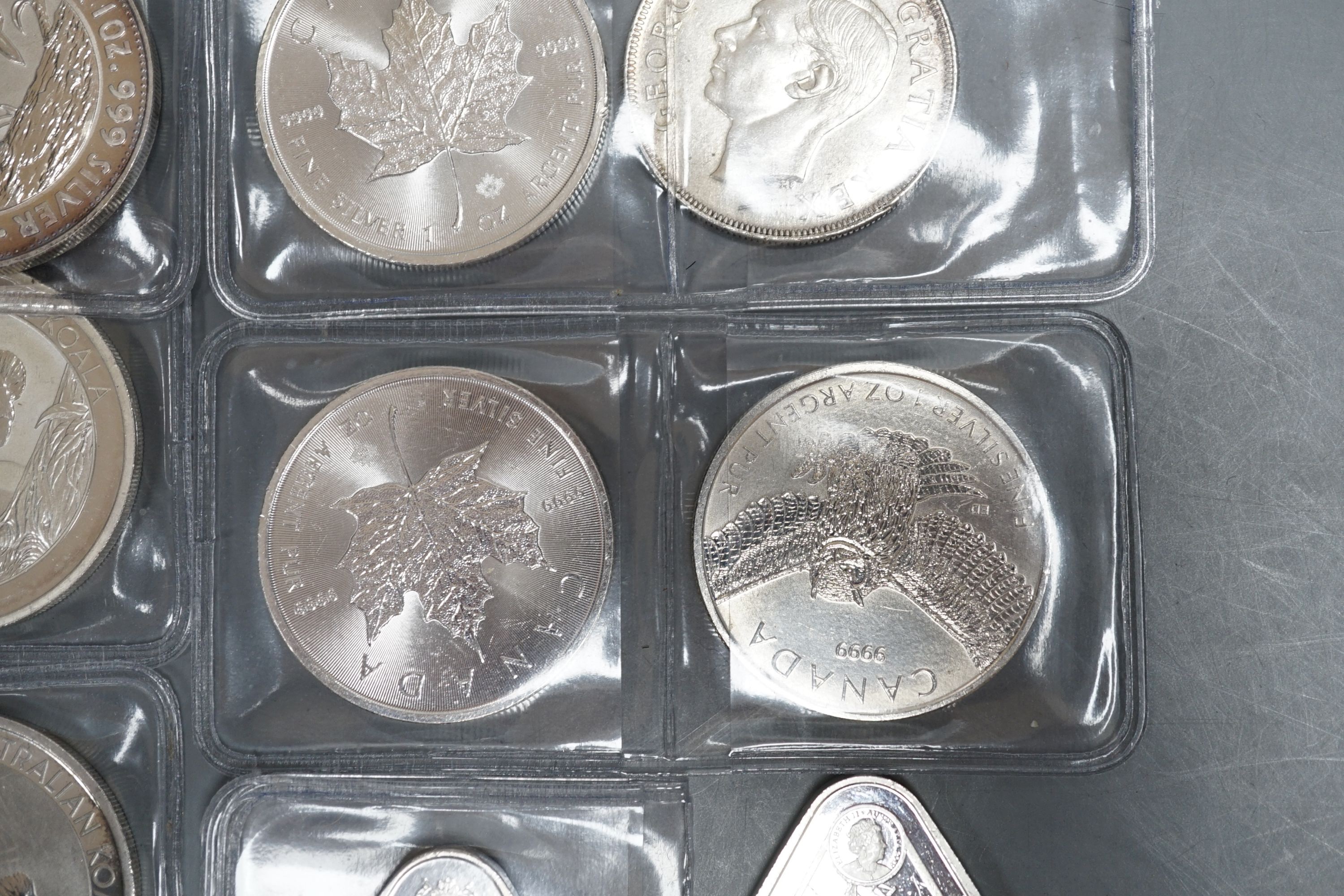 Eight 1oz assorted Australian 1 dollar coins, finesse .999, four 1oz assorted Canadian dollar coins, two silver 1oz coins- Britannia 2019 and George & Dragon, 2021 and two silver Australian triangular 1oz coins, 2019/202